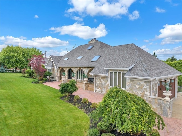 rear view of house with a patio and a yard