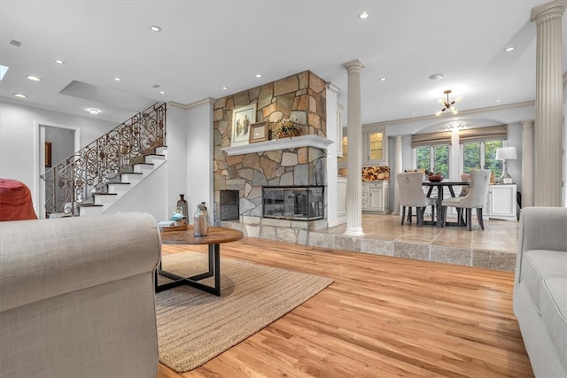 tiled living room with ornate columns and a fireplace