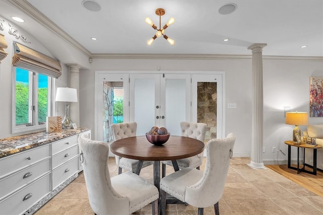 tiled dining space featuring a notable chandelier, ornamental molding, decorative columns, and french doors