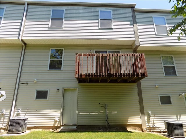 rear view of property with central AC