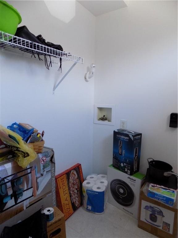 clothes washing area featuring washer hookup and laundry area