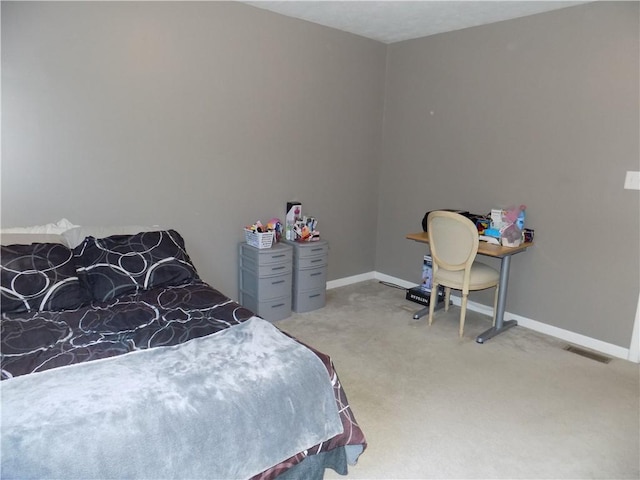 carpeted bedroom with visible vents and baseboards