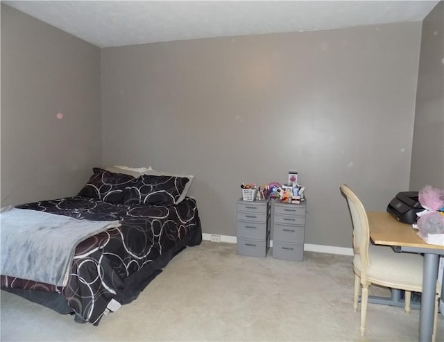 bedroom with light carpet and baseboards