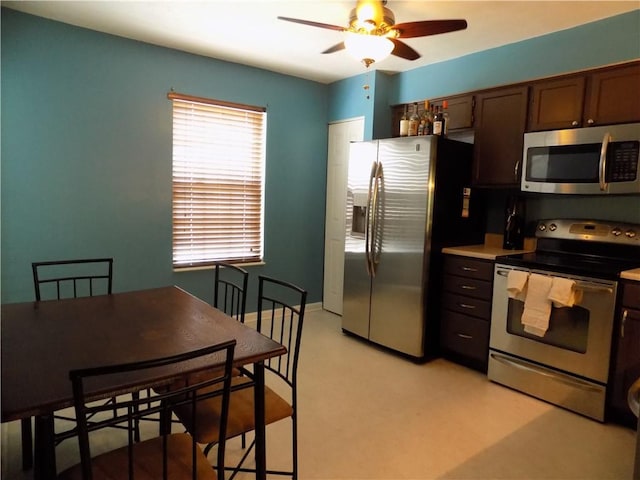 kitchen with light floors, light countertops, appliances with stainless steel finishes, ceiling fan, and baseboards