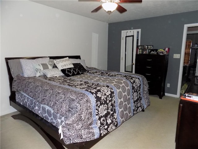 bedroom with a ceiling fan, light carpet, and baseboards