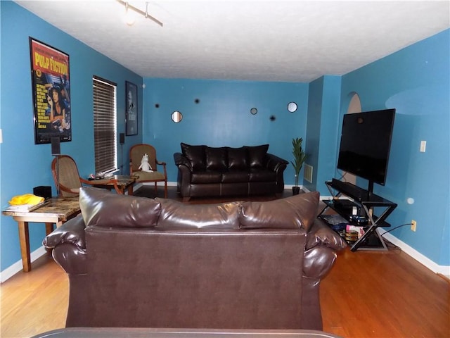 living room featuring wood finished floors and baseboards