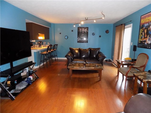 living room with light wood finished floors and baseboards