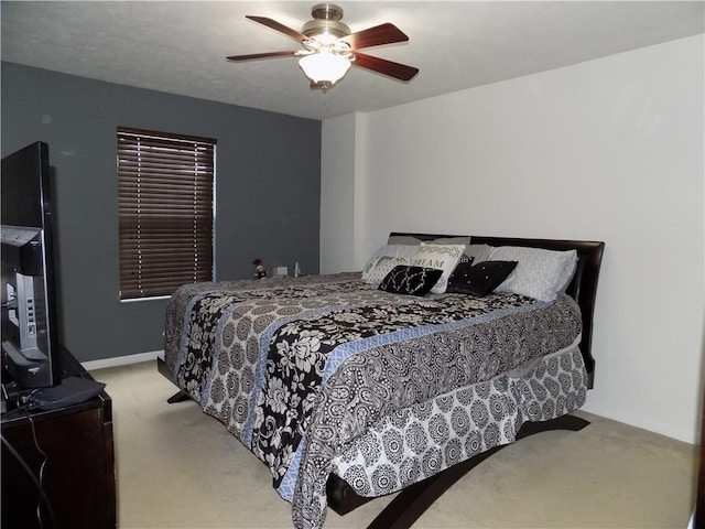 bedroom with light carpet and ceiling fan