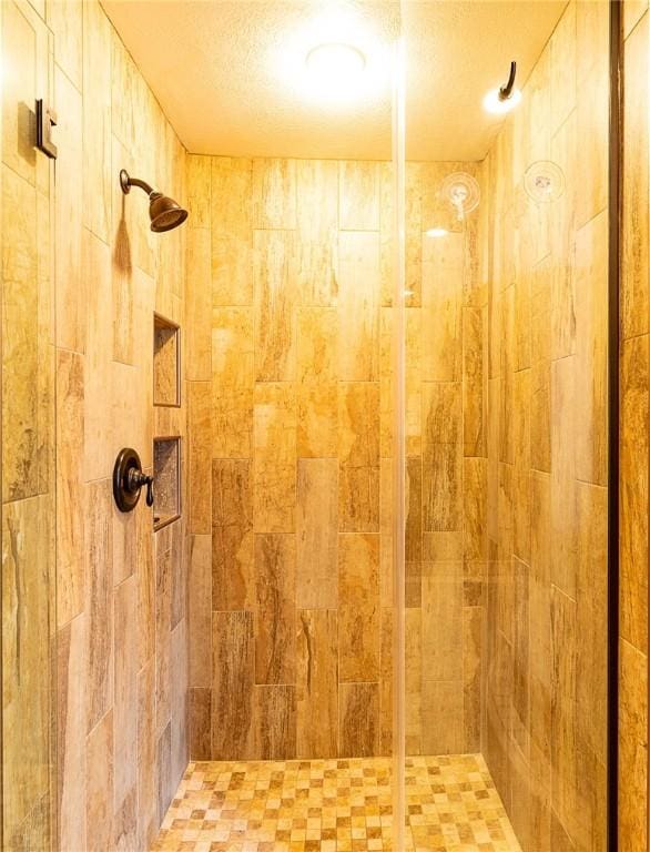 bathroom with a tile shower