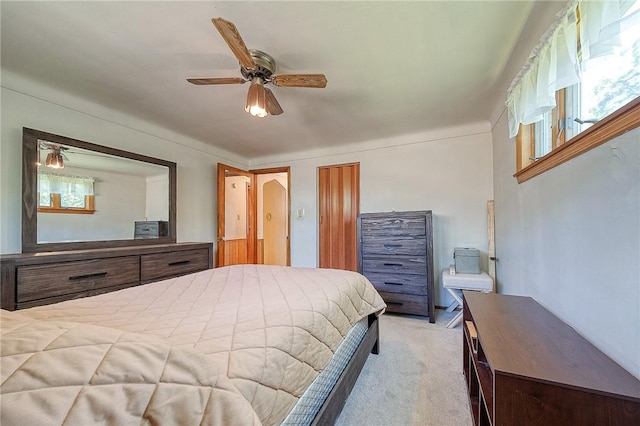 bedroom featuring ceiling fan and light carpet