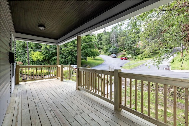 wooden terrace featuring covered porch