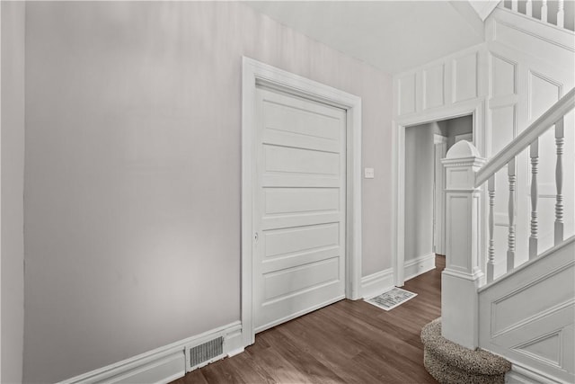 foyer entrance with dark wood-type flooring