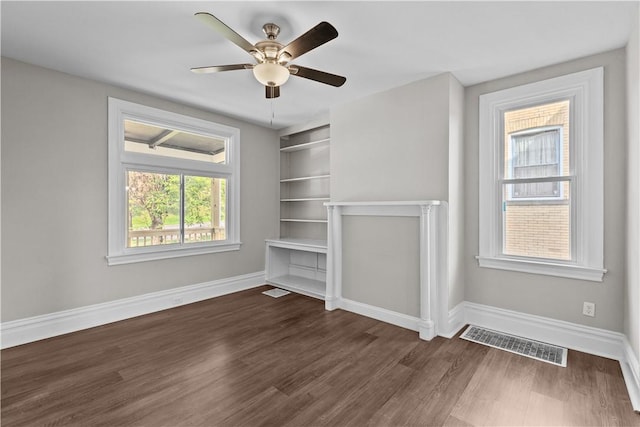 unfurnished living room with dark hardwood / wood-style floors, plenty of natural light, and ceiling fan