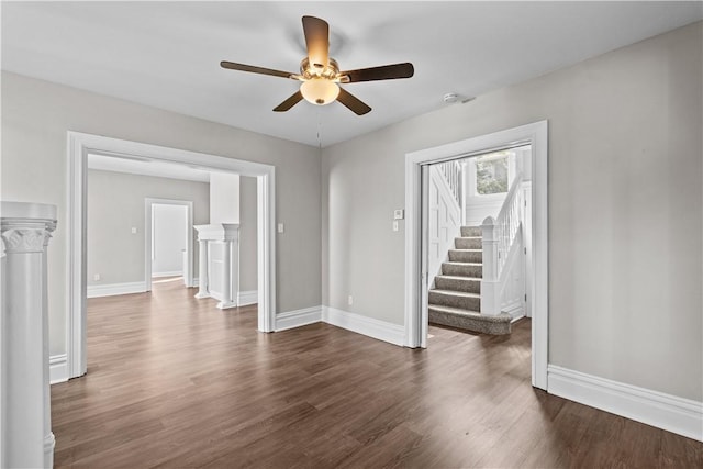 unfurnished living room with ceiling fan and dark hardwood / wood-style flooring