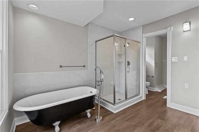 bathroom featuring tile walls, wood-type flooring, shower with separate bathtub, and toilet