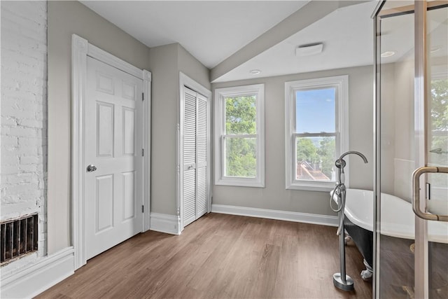 workout area featuring a fireplace and hardwood / wood-style floors