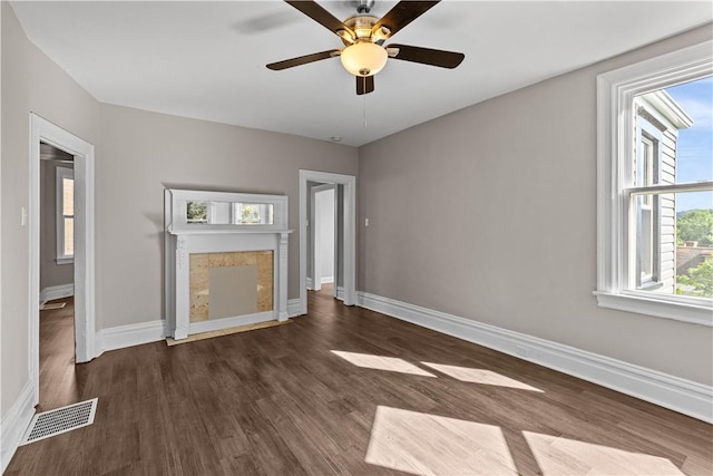 unfurnished living room with ceiling fan and dark wood-type flooring