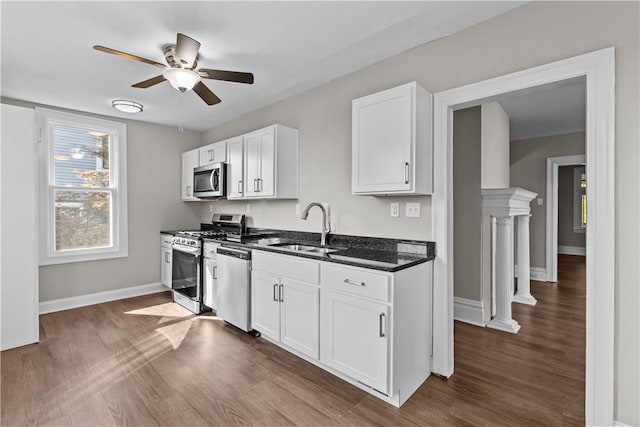 kitchen featuring white cabinets, sink, stainless steel appliances, and dark wood-type flooring