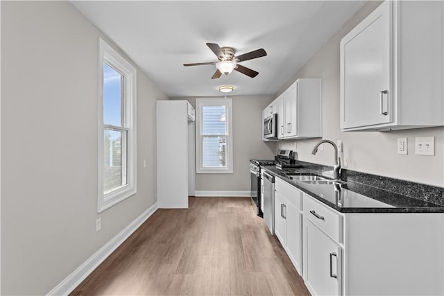 kitchen featuring white cabinets, sink, appliances with stainless steel finishes, and hardwood / wood-style floors