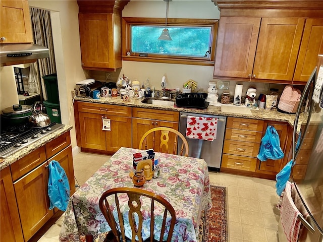 kitchen featuring stainless steel appliances, sink, light tile floors, and light stone counters