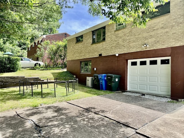 view of property exterior with central AC and a lawn