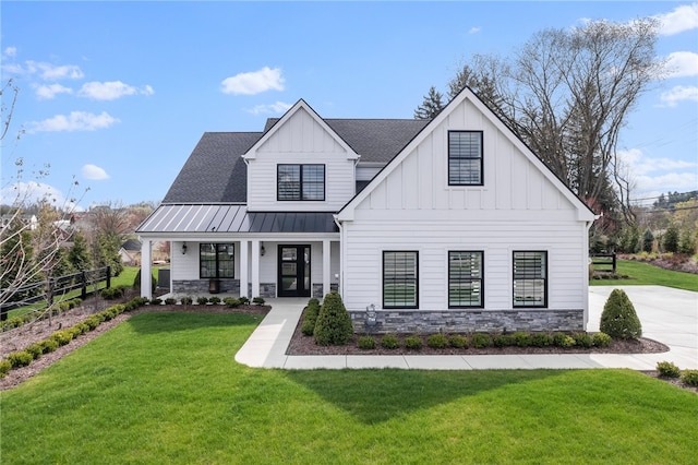 modern farmhouse style home featuring a front yard and a porch