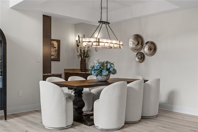 dining area with an inviting chandelier and wood-type flooring