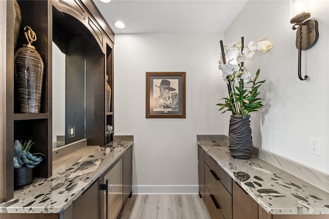 interior space with vanity and hardwood / wood-style flooring