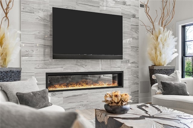 living room featuring wood-type flooring and tile walls