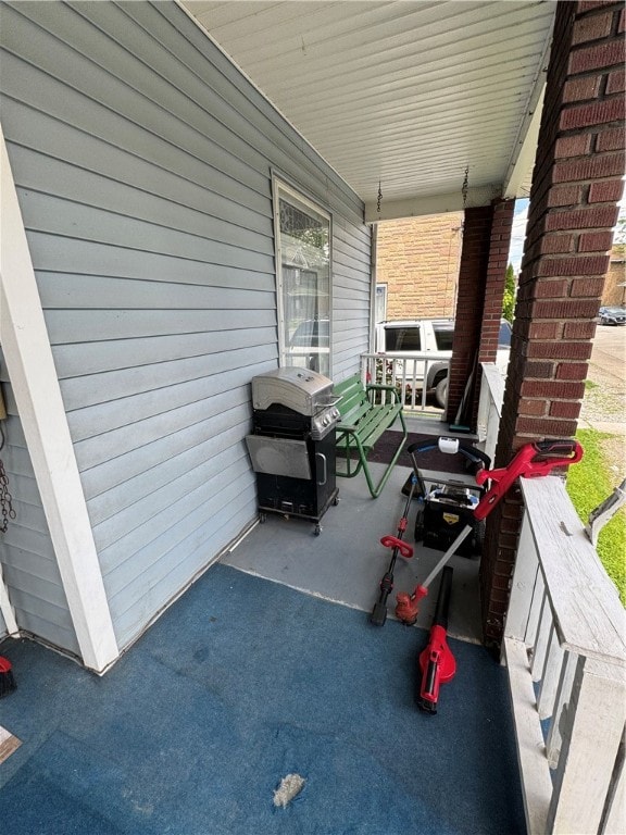 view of patio featuring a grill and a porch