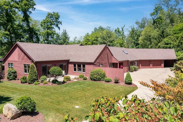 single story home featuring a garage and a front yard