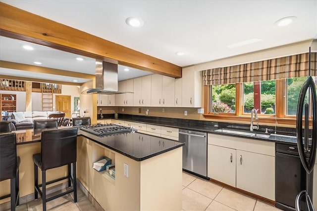 kitchen featuring island exhaust hood, appliances with stainless steel finishes, sink, beamed ceiling, and white cabinetry