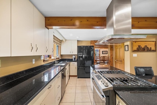 kitchen featuring island exhaust hood, sink, dark stone countertops, and appliances with stainless steel finishes