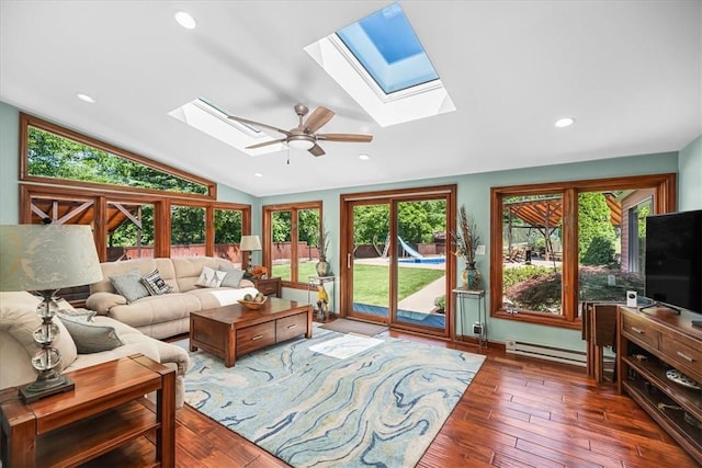 living room featuring ceiling fan, a healthy amount of sunlight, dark hardwood / wood-style flooring, and lofted ceiling