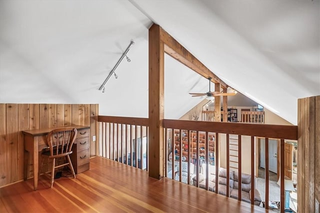 bonus room featuring wood walls, vaulted ceiling, and hardwood / wood-style flooring