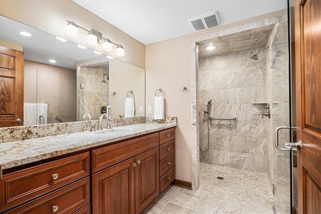 bathroom featuring vanity and an enclosed shower