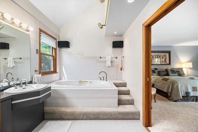 bathroom featuring vanity, lofted ceiling, and tiled bath