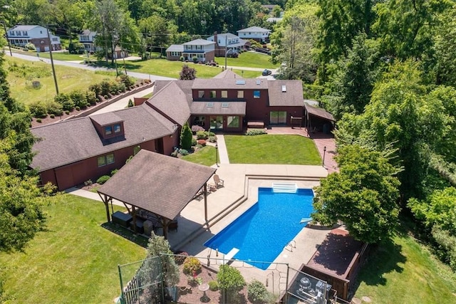 view of pool with a diving board and a patio