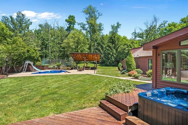 view of yard featuring a pool with hot tub