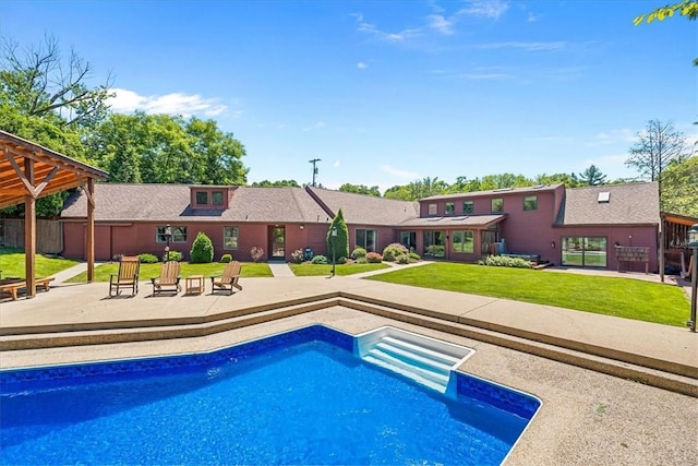 view of pool with a yard and a patio area