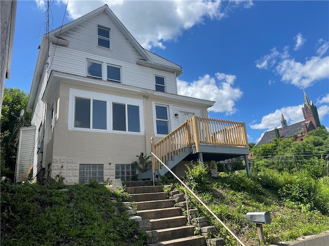 rear view of property with a wooden deck