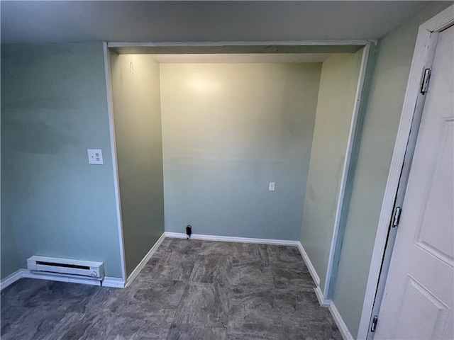 clothes washing area featuring baseboard heating and dark tile floors