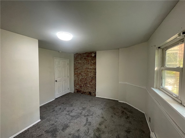 empty room featuring dark colored carpet