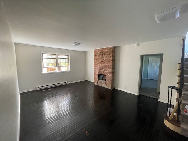 living room featuring a fireplace, dark hardwood / wood-style flooring, a baseboard radiator, and brick wall