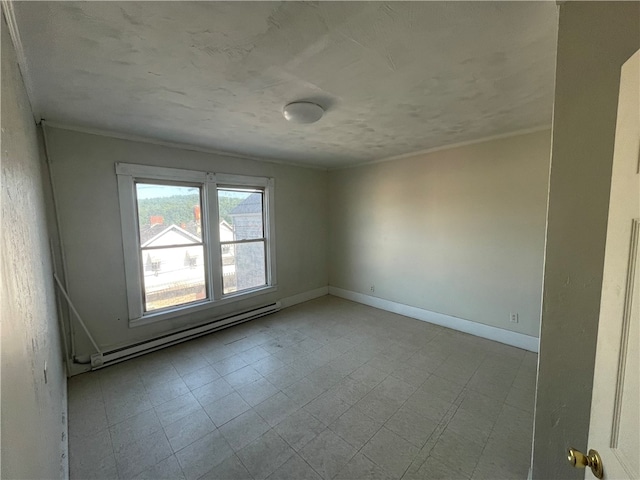 tiled spare room featuring a baseboard heating unit