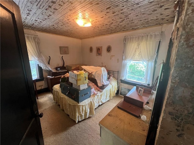 carpeted bedroom with wooden ceiling