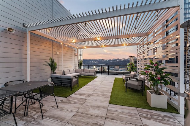 patio terrace at dusk with an outdoor living space and a pergola