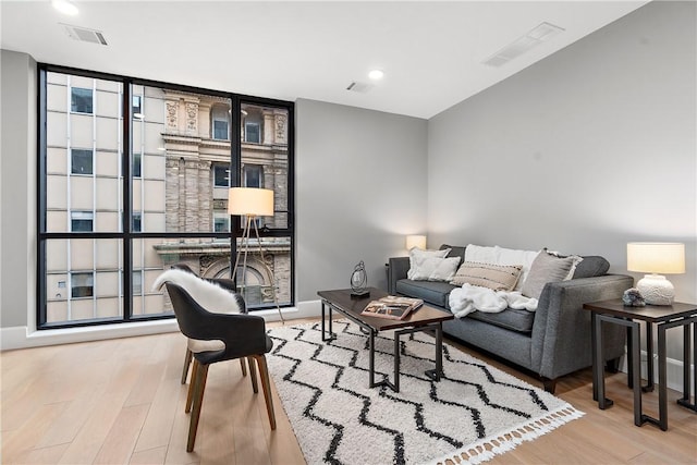 living area featuring wood finished floors and visible vents
