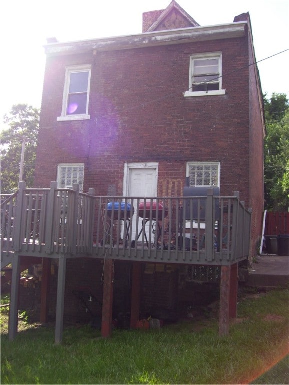 rear view of property featuring a wooden deck