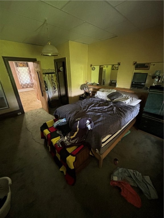 bedroom with carpet and a paneled ceiling